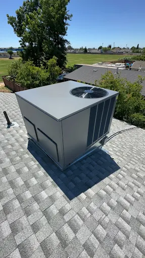 Professional rooftop HVAC unit installation showing proper installation and connection work in Central Valley