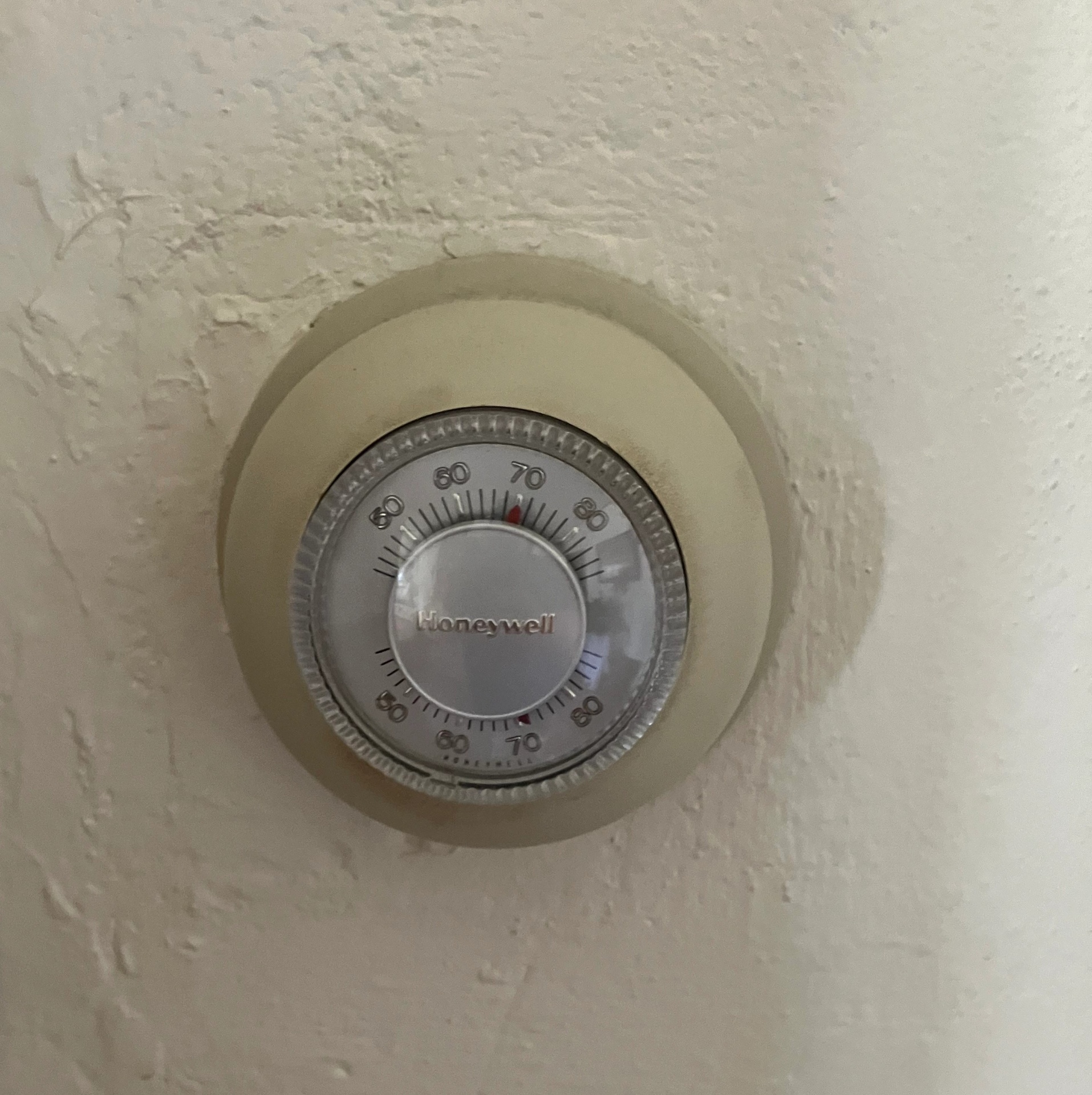 Old analog Honeywell thermostat being replaced by HVAC Penguin in Turlock CA